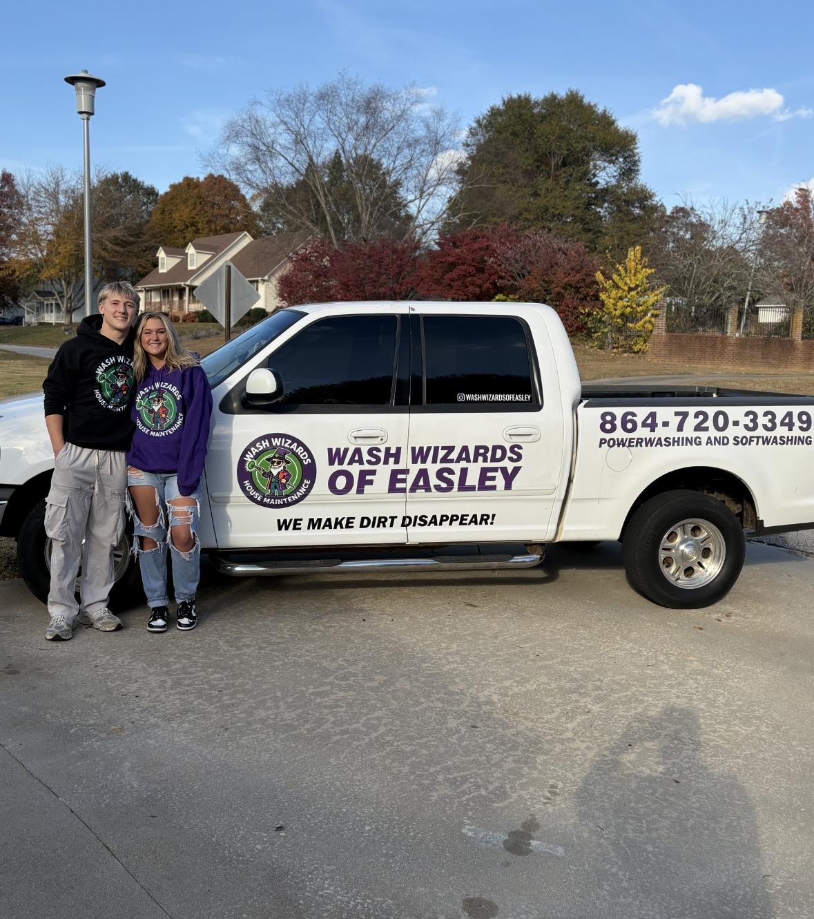 Wash Wizards of Easley owners standing beside branded work truck